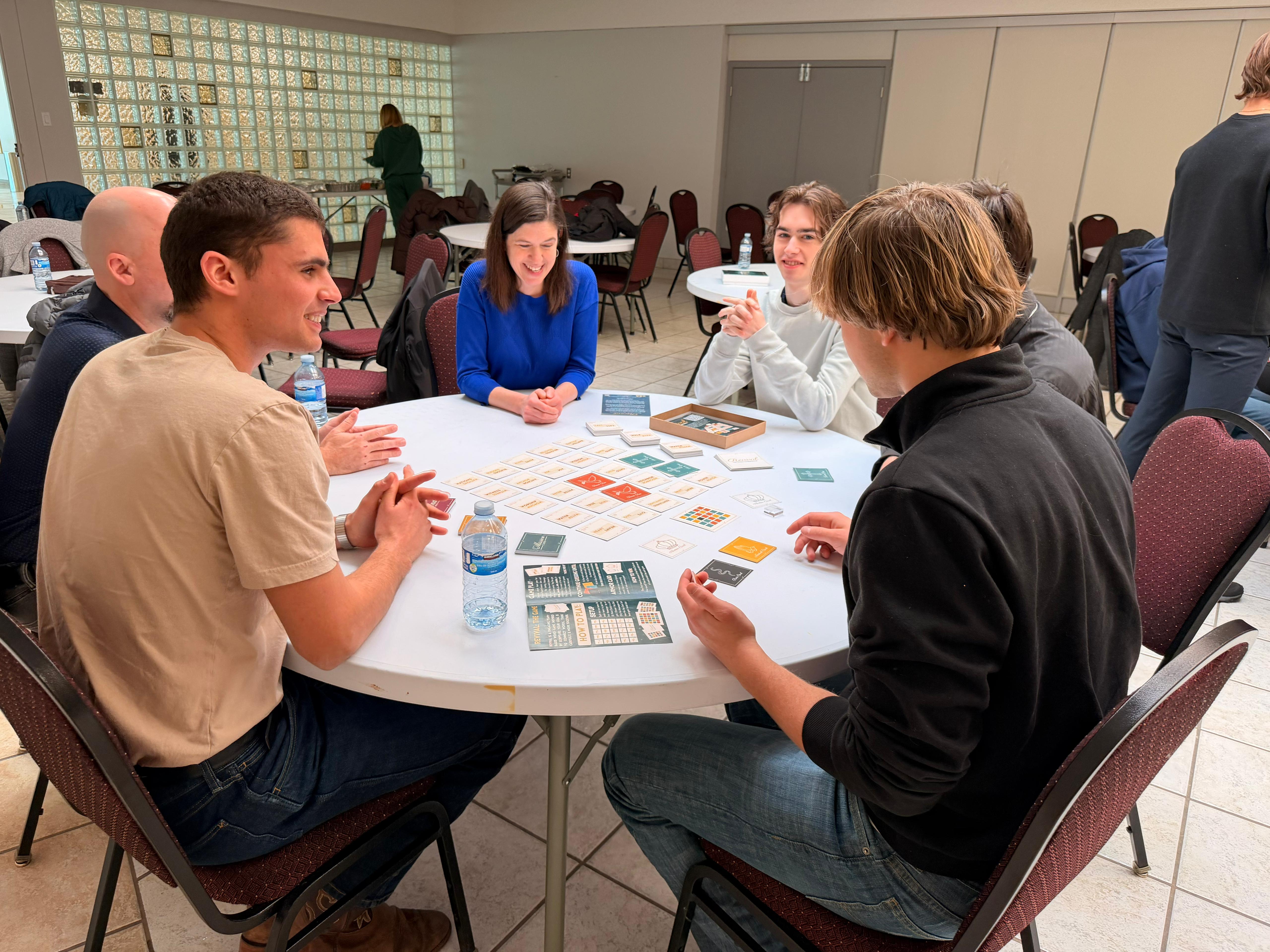Group playing Revival around a round table in a church hall